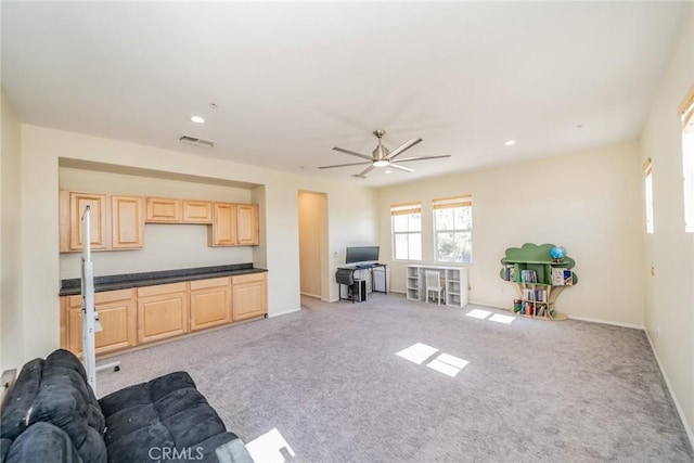living area with light carpet, baseboards, a ceiling fan, and visible vents