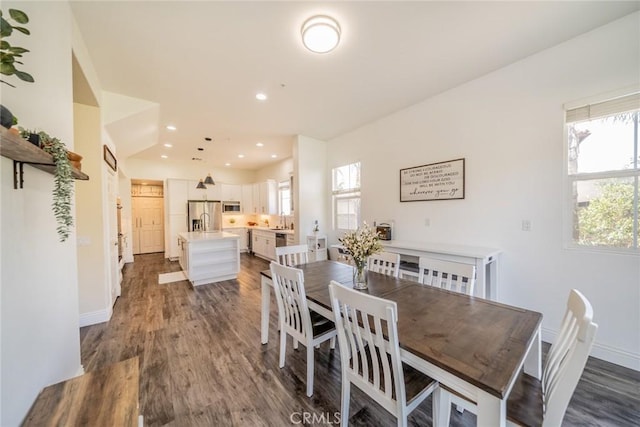 dining area with dark wood-style flooring, baseboards, and recessed lighting