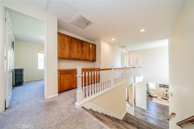 stairs with visible vents, baseboards, and recessed lighting