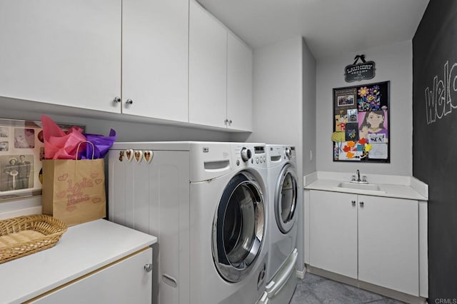 laundry room with a sink, washing machine and dryer, and cabinet space
