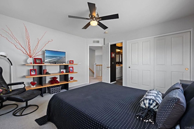 bedroom featuring ensuite bathroom, a closet, visible vents, carpet flooring, and a ceiling fan