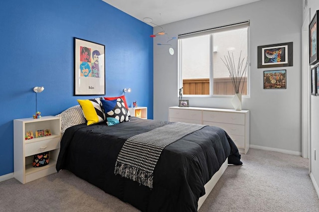 bedroom with baseboards and carpet floors