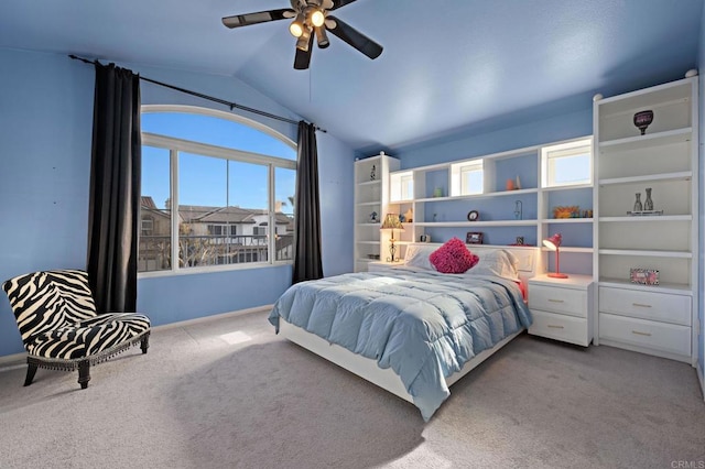 carpeted bedroom with lofted ceiling, multiple windows, baseboards, and a ceiling fan