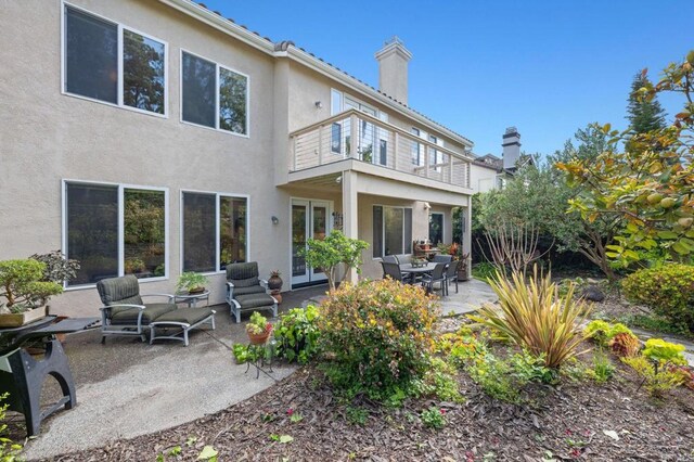 5054 Seachase Way, San Diego, CA 92130 - rear view of house with a balcony, a chimney, stucco siding, a patio, and french doors
