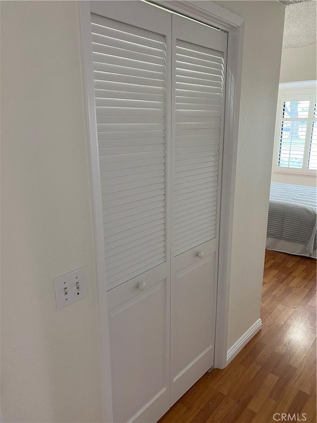 details featuring wood finished floors and baseboards