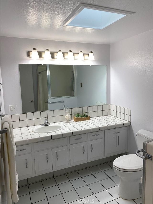 full bath featuring toilet, tile patterned flooring, and vanity