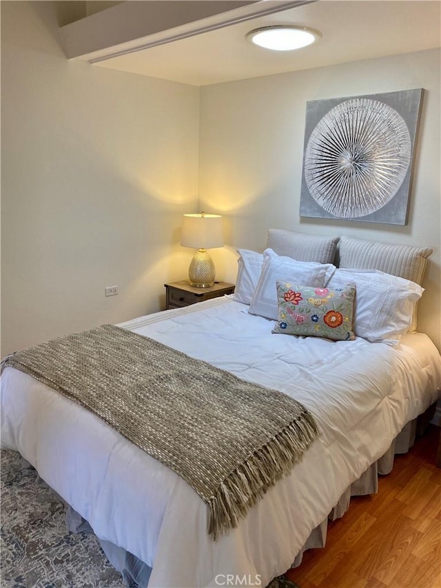 bedroom featuring wood finished floors