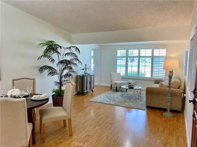 13310 Fairfield Ln Unit M7-176B, Seal Beach, CA 90740 - living area featuring a textured ceiling, light wood-style floors, and baseboards