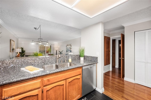 kitchen featuring stainless steel dishwasher, a sink, ornamental molding, dark wood-style flooring, and a textured ceiling