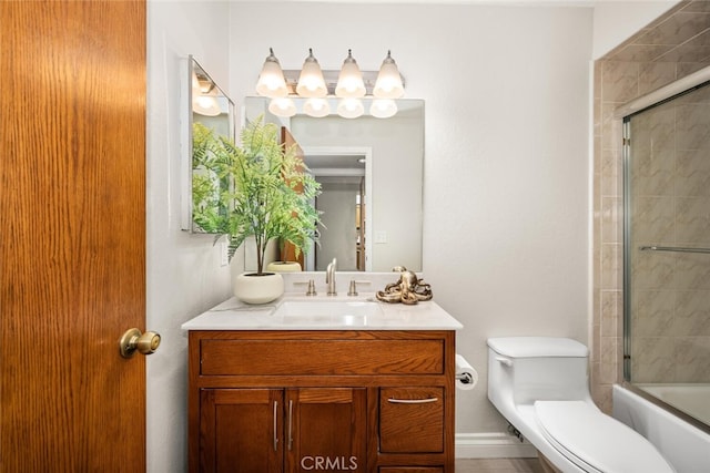 full bath featuring toilet, vanity, and enclosed tub / shower combo