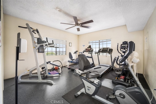 workout area featuring ceiling fan and a textured ceiling