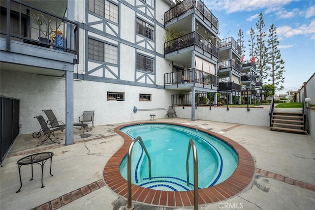 community pool featuring a patio area