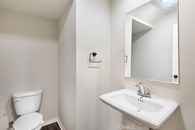2785 Berry Loop Privado Unit 12, Ontario, CA 91761 - half bath with a sink, toilet, wood finished floors, and baseboards