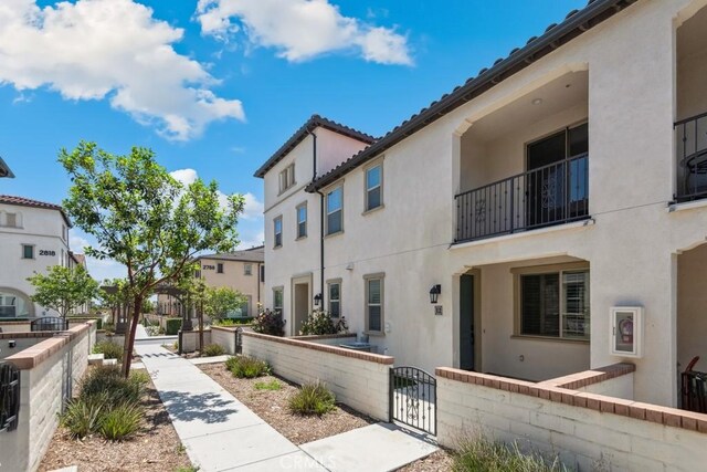 2785 Berry Loop Privado Unit 12, Ontario, CA 91761 - surrounding community with a fenced front yard, a gate, and a residential view