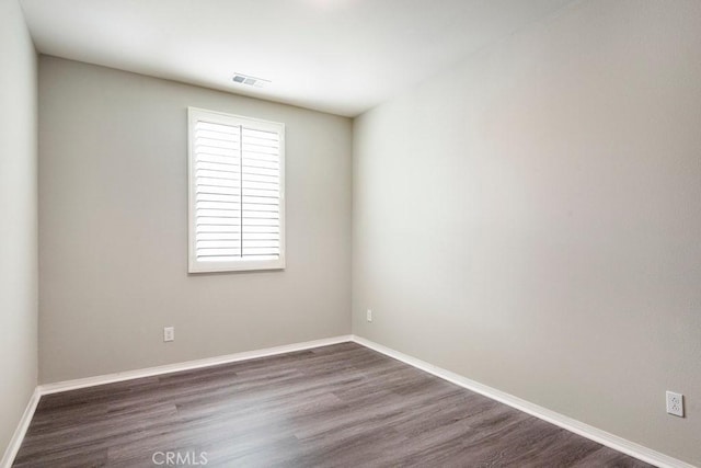 2785 Berry Loop Privado Unit 12, Ontario, CA 91761 - spare room featuring dark wood-style flooring and baseboards