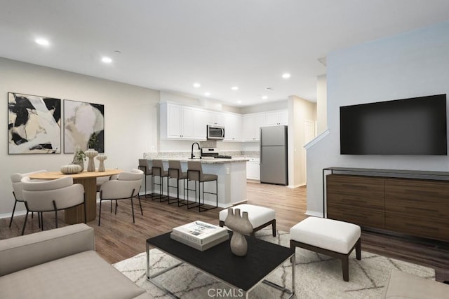 2785 Berry Loop Privado Unit 12, Ontario, CA 91761 - living area with light wood-style flooring, baseboards, and recessed lighting