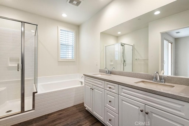 2785 Berry Loop Privado Unit 12, Ontario, CA 91761 - full bathroom featuring a shower stall, a garden tub, double vanity, wood finished floors, and recessed lighting