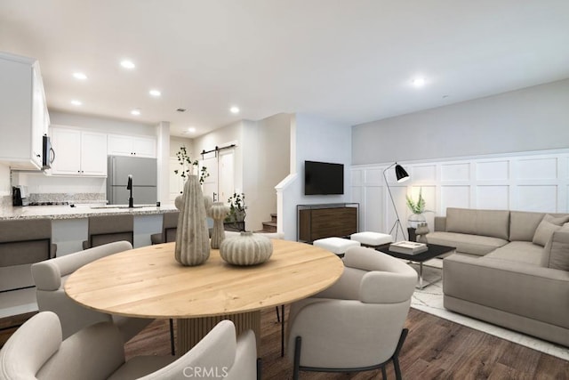 2785 Berry Loop Privado Unit 12, Ontario, CA 91761 - dining space featuring a barn door, dark wood-style flooring, and recessed lighting