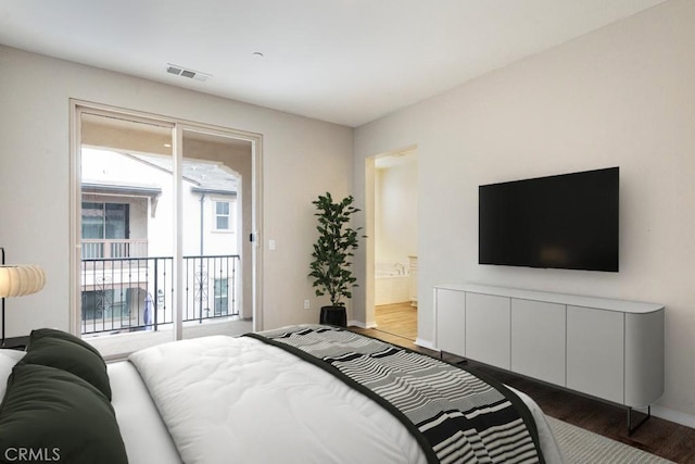 2785 Berry Loop Privado Unit 12, Ontario, CA 91761 - bedroom featuring dark wood-style flooring, access to exterior, baseboards, and connected bathroom