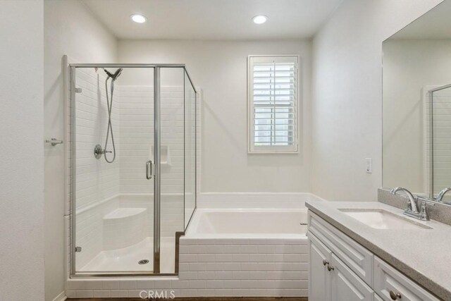 2785 Berry Loop Privado Unit 12, Ontario, CA 91761 - bathroom with a stall shower, vanity, a garden tub, and recessed lighting