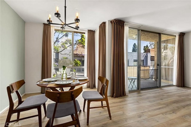 5875 Doverwood Dr Unit 309, Culver City, CA 90230 - dining room with expansive windows, a chandelier, light wood-type flooring, plenty of natural light, and baseboards