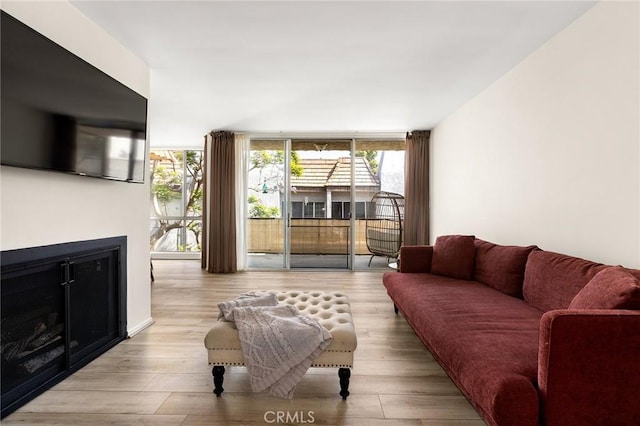 5875 Doverwood Dr Unit 309, Culver City, CA 90230 - living area with a glass covered fireplace, wood finished floors, and expansive windows