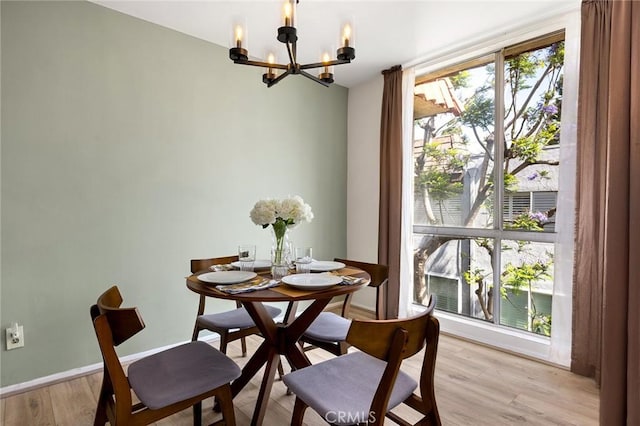 5875 Doverwood Dr Unit 309, Culver City, CA 90230 - dining space with a chandelier, light wood finished floors, and baseboards