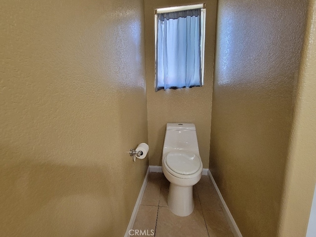 628 Vintner St, Los Banos, CA 93635 - bathroom featuring toilet, tile patterned flooring, and baseboards