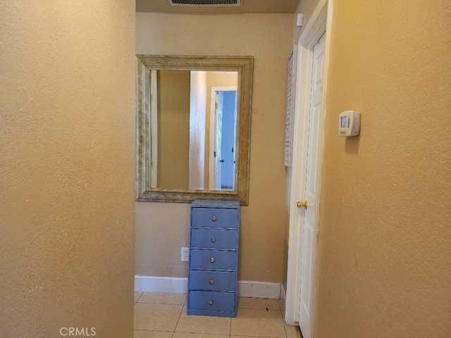 628 Vintner St, Los Banos, CA 93635 - hallway featuring light tile patterned floors, baseboards, visible vents, and a textured wall