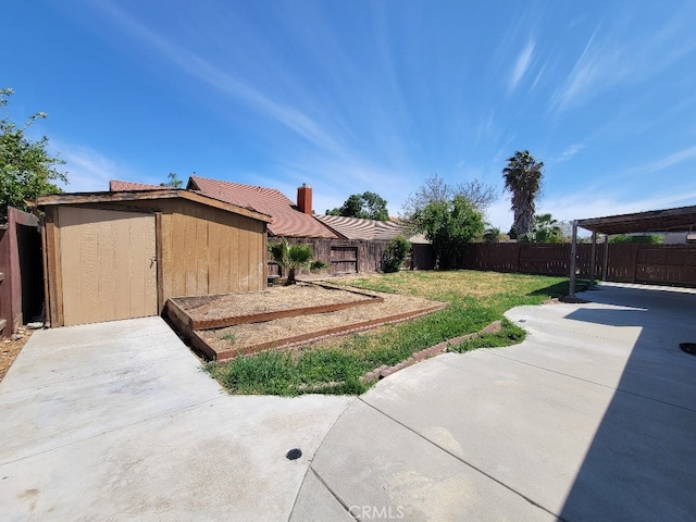 628 Vintner St, Los Banos, CA 93635 - view of yard featuring a patio, an outbuilding, a fenced backyard, and a storage unit