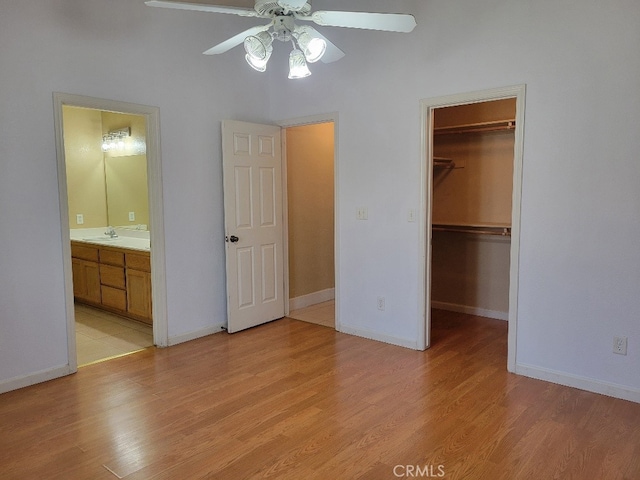 628 Vintner St, Los Banos, CA 93635 - unfurnished bedroom with a sink, a walk in closet, and light wood-style floors