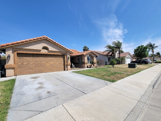628 Vintner St, Los Banos, CA 93635 - view of front of home featuring an attached garage, stucco siding, a tile roof, concrete driveway, and a front lawn