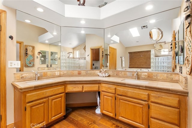 22255 Village Way Dr, Canyon Lake, CA 92587 - bathroom with wood finished floors, double vanity, a tile shower, and recessed lighting