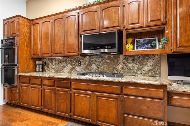 22255 Village Way Dr, Canyon Lake, CA 92587 - kitchen featuring stainless steel appliances, backsplash, wood finished floors, and light stone countertops