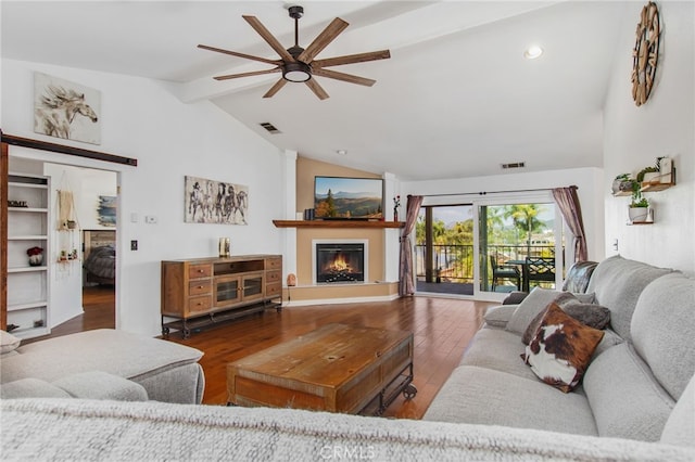 22255 Village Way Dr, Canyon Lake, CA 92587 - living area with a ceiling fan, beam ceiling, wood finished floors, a glass covered fireplace, and high vaulted ceiling