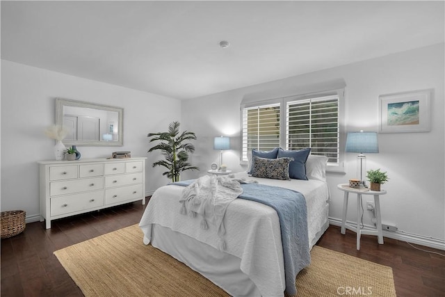 bedroom featuring baseboards and wood finished floors