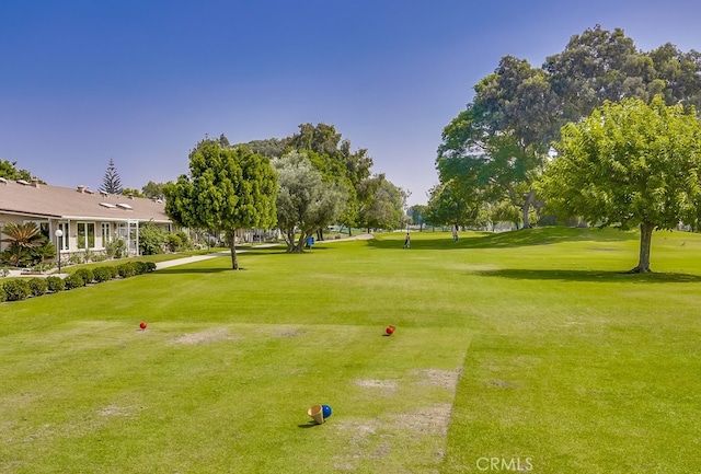 view of community with a yard and golf course view