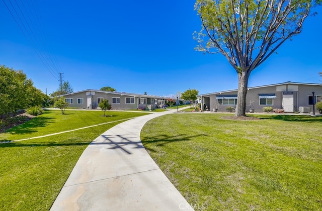 view of home's community with a lawn
