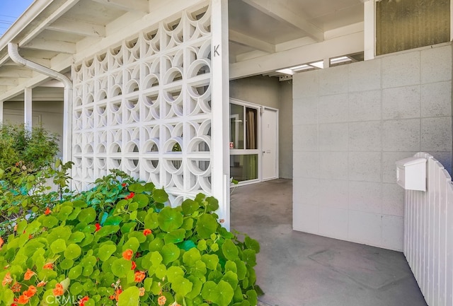 doorway to property featuring concrete block siding