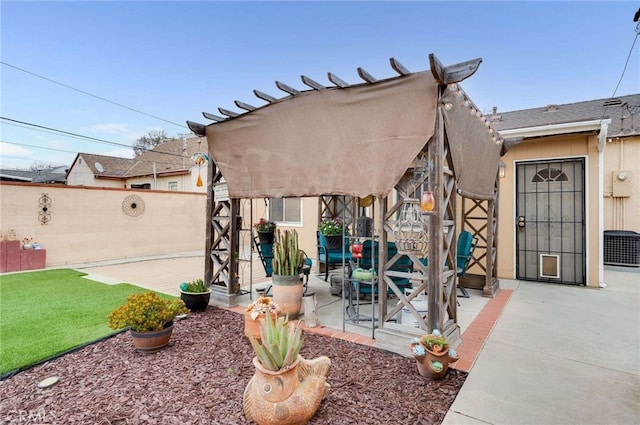view of front of property with a fenced backyard, a patio, stucco siding, and a front lawn