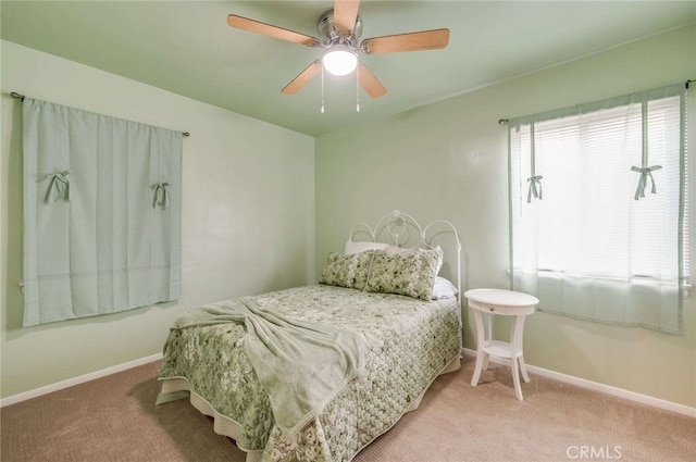 bedroom featuring carpet, baseboards, and a ceiling fan