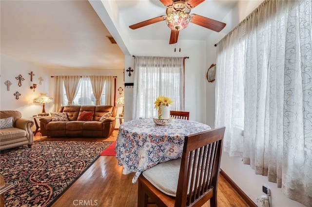dining space featuring ceiling fan, visible vents, wood finished floors, and a healthy amount of sunlight