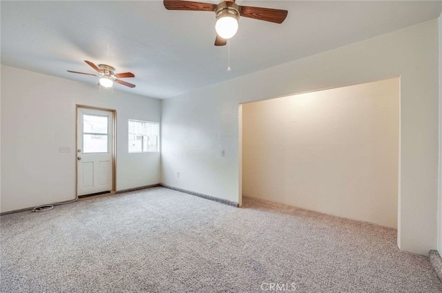unfurnished room featuring light carpet and a ceiling fan