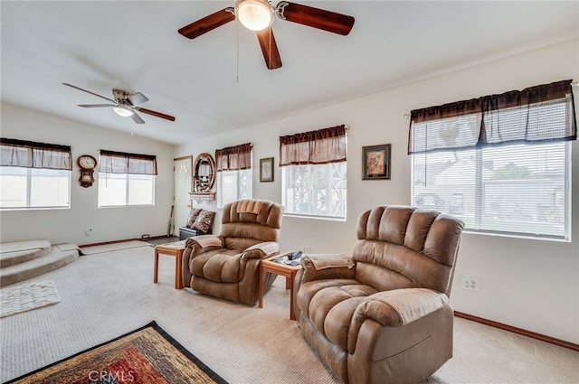 living area featuring light colored carpet, vaulted ceiling, baseboards, and ceiling fan