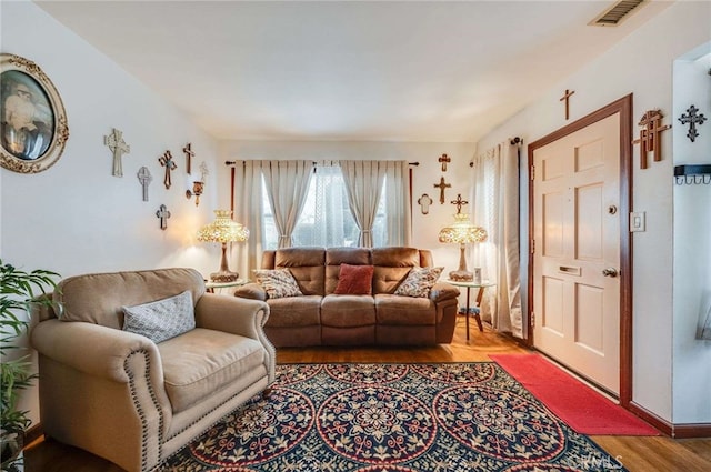 living room featuring light wood-style floors and visible vents
