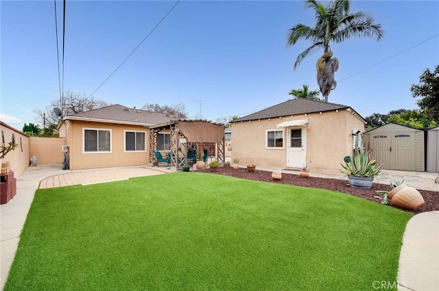 rear view of property with stucco siding, a patio, an outbuilding, and a shed