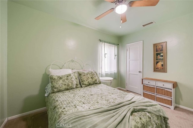 bedroom featuring baseboards, ceiling fan, visible vents, and carpet