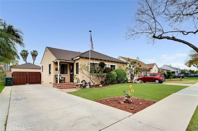 view of front of property featuring a front yard, stucco siding, and driveway