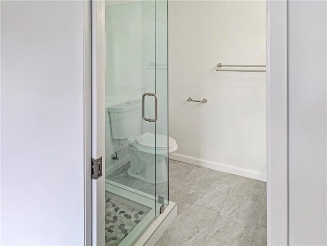 26770 Claudette St Unit 408, Canyon Country, CA 91351 - bathroom featuring toilet, baseboards, and a stall shower