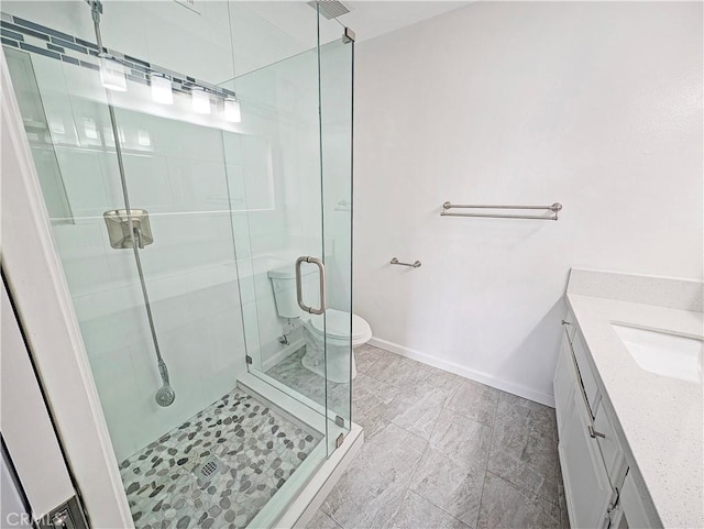 26770 Claudette St Unit 408, Canyon Country, CA 91351 - bathroom featuring vanity, baseboards, a shower stall, and toilet